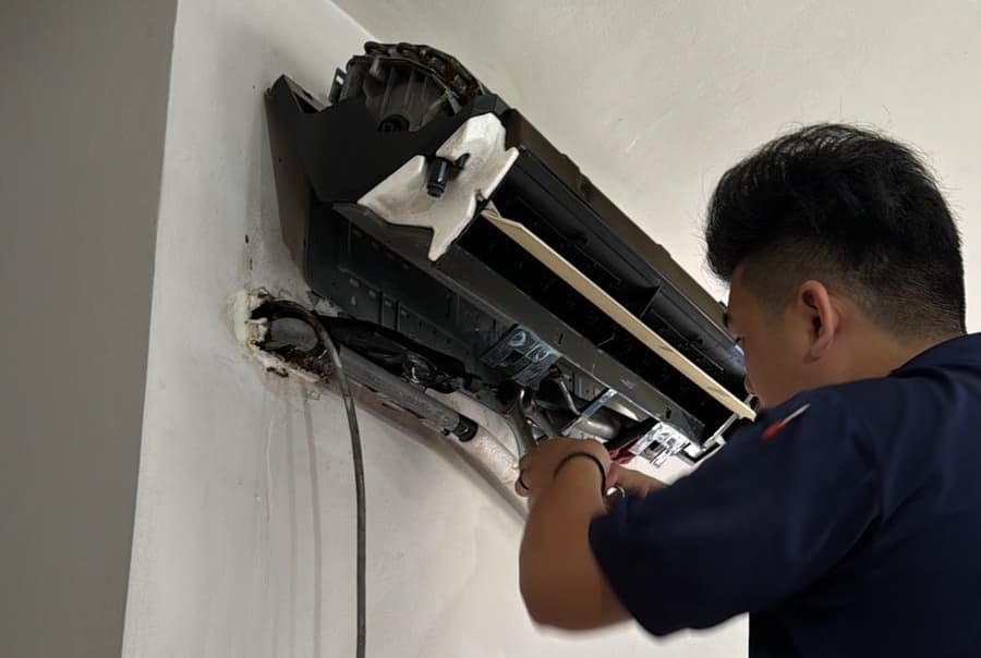 Aircon technician servicing unit