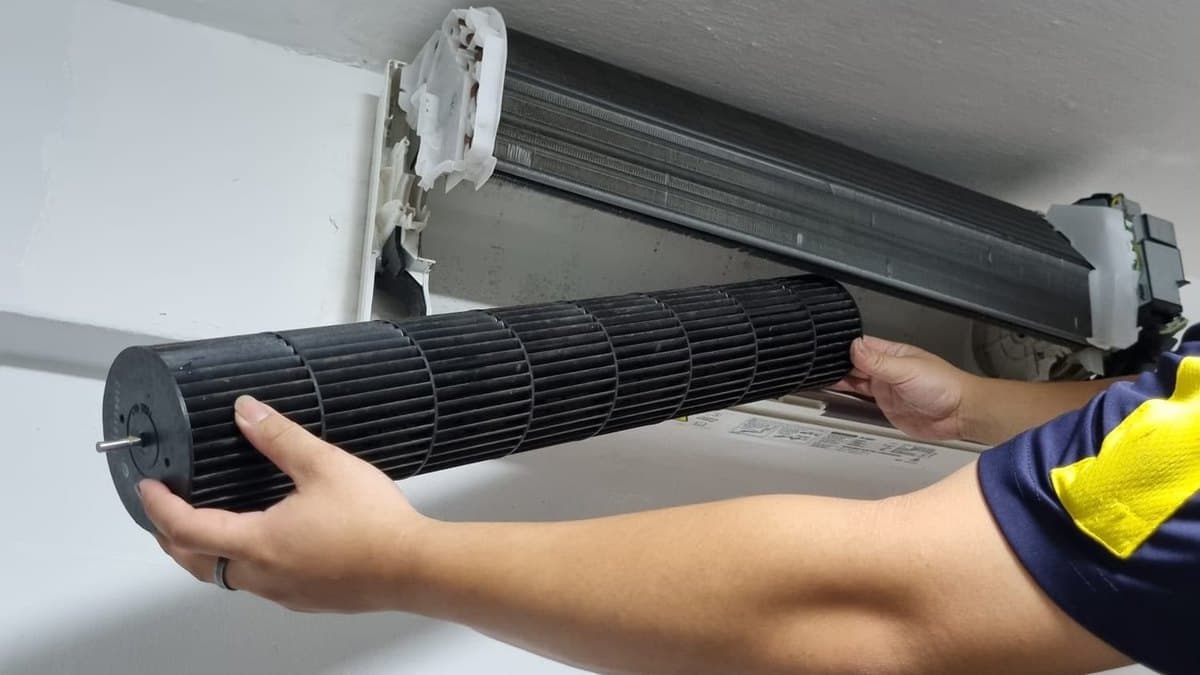 Grime-covered aircon blower wheel removed from the indoor unit